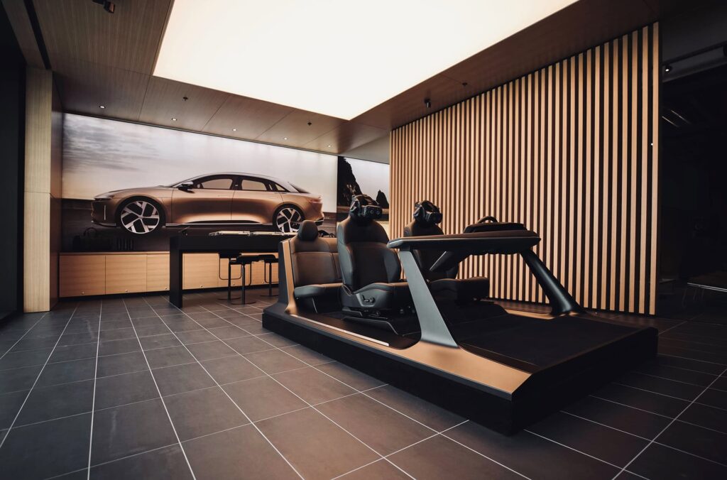 Lucid Air demo driver and passenger seats with console in a Studio showroom