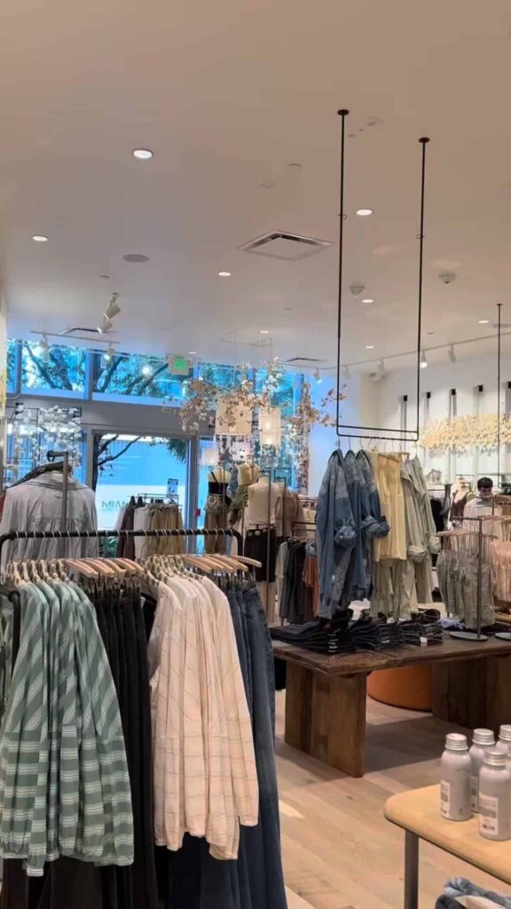 Racks of fashionable women’s clothing at Free People Miami Worlcenter