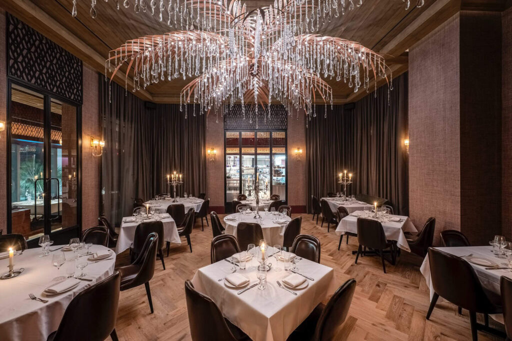 Maple & Ash dining room featuring a palm tree-shaped crystal chandelier