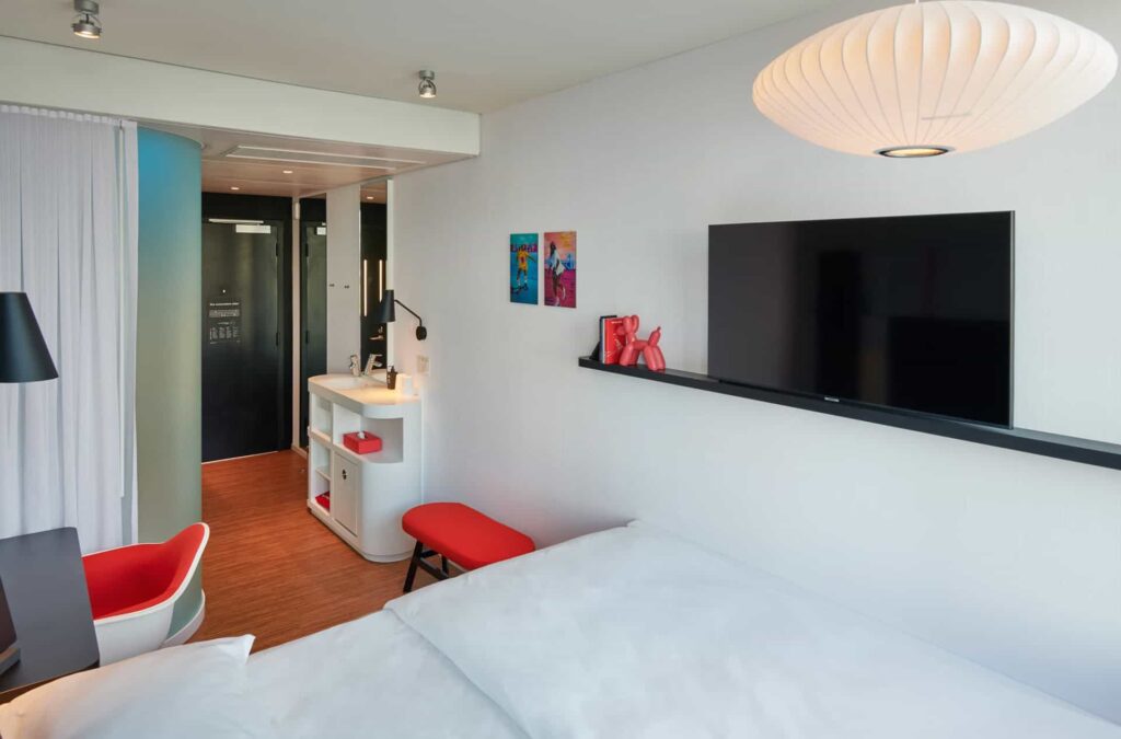 Guest bedroom with wall-mounted TV at citizenM Miami Worldcenter Hotel