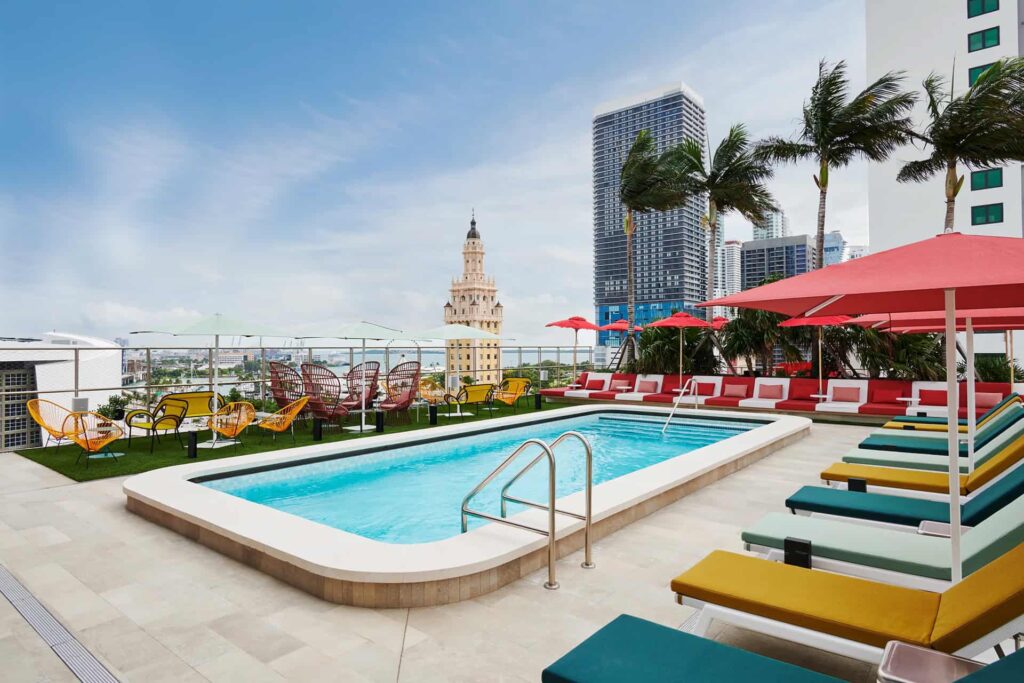 Rooftop pool surrounded by sun loungers at citizenM Miami Worldcenter