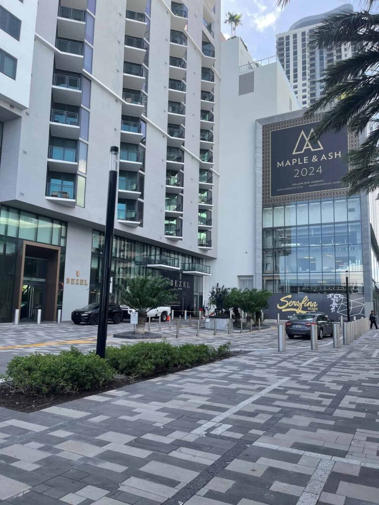 Parking area outside Bezel Miami Worldcenter with Coming Soon banners for Maple & Ash and Serafina Miami