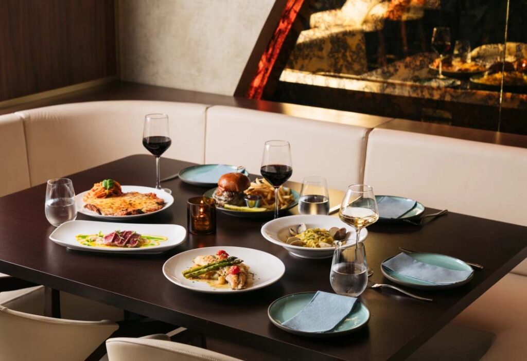 Plates of signature dishes at a table at Serafina Miami Worldcenter (Photo: Modern Luxury)