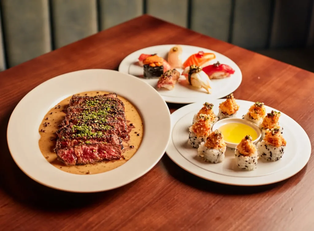 Assorted plates featuring steak and sushi at Eight Bar